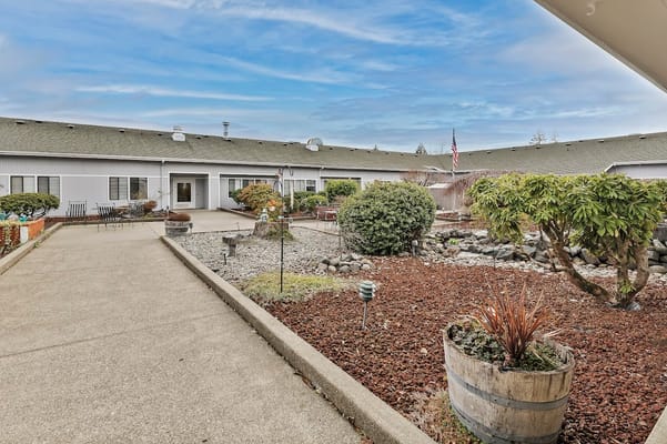 View of the landscaped courtyard with seating at Puget Health Care Center
