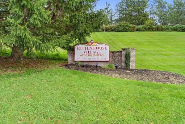 Sign for Rittenhouse Village at Muhlenberg on a grassy area