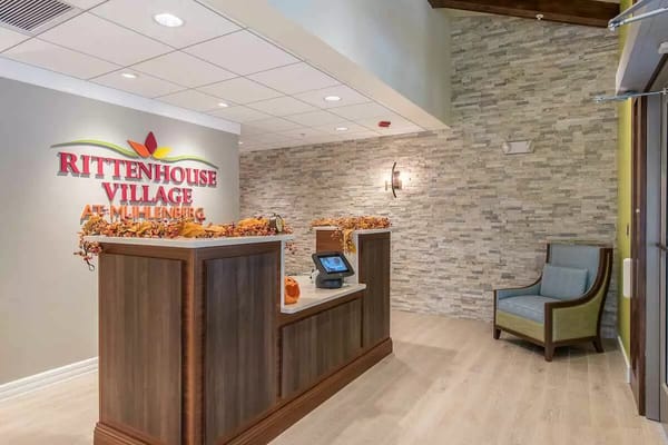 Welcoming reception desk with decorative autumn elements at Rittenhouse Village.