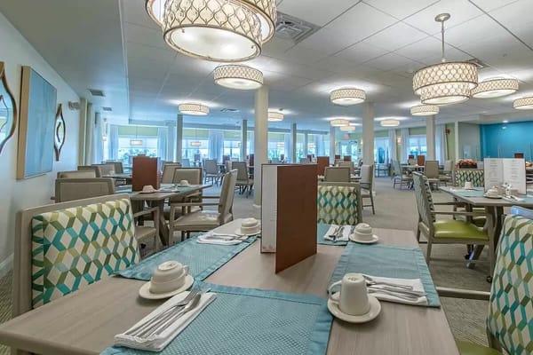 Spacious dining area with tables set for meals.