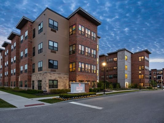 Modern brick buildings of Rose Senior Living Carmel at dusk