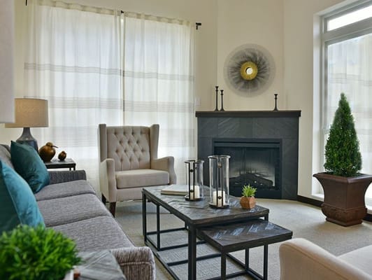 A cozy living room with a fireplace and comfortable seating.