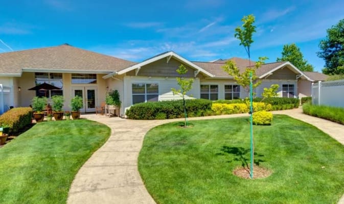 Exterior of Rosewood Memory Care with landscaped garden and pathways