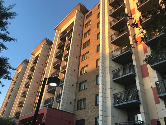 Exterior view of apartment building with balconies at sunset