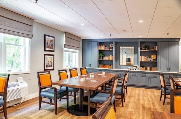 Dining area with tables and chairs in a bright room