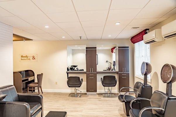 Interior view of a salon area with chairs and stations