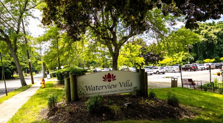 Sign for Waterview Villa surrounded by greenery