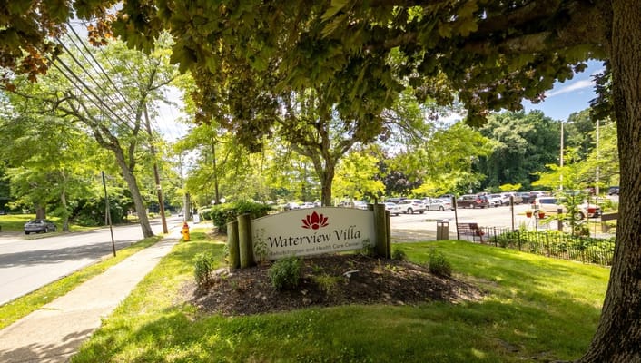 Waterview Villa sign in a green outdoor space