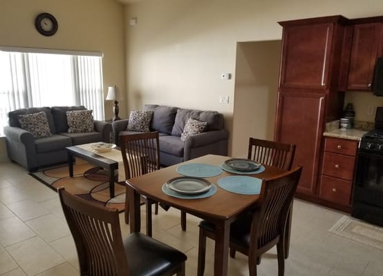 Bright interior living space with couches and dining table