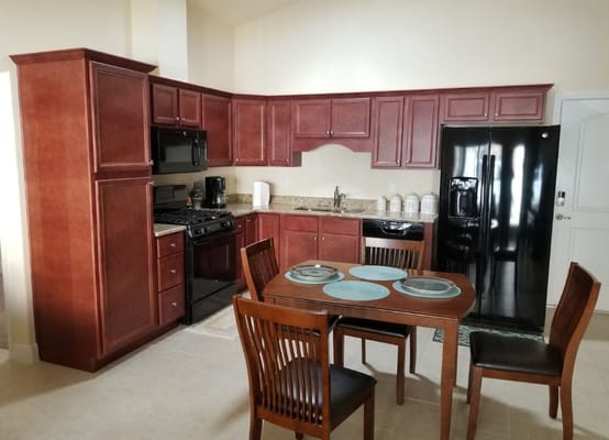 Bright kitchen area with dining table and appliances