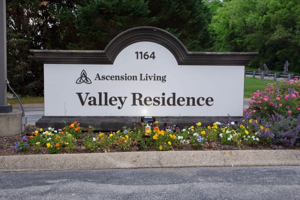 Exterior sign for Valley Residence with flowers