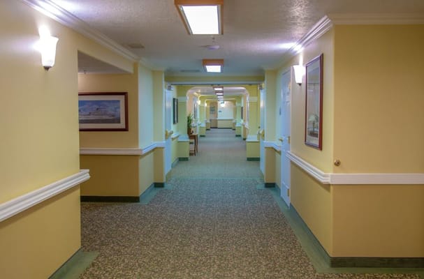 Bright, well-lit hallway in a senior living facility