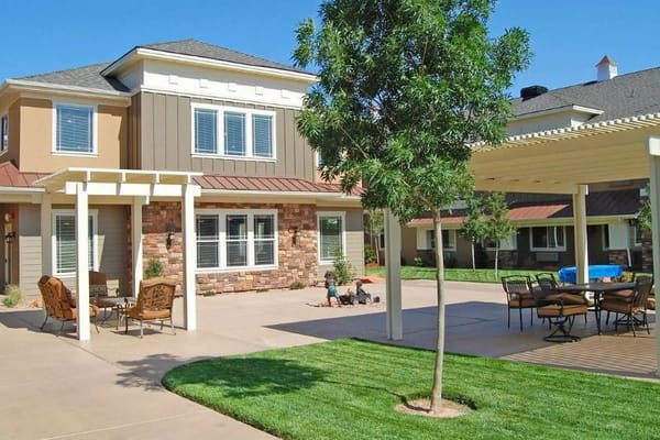 Outdoor view of a senior living facility with seating area