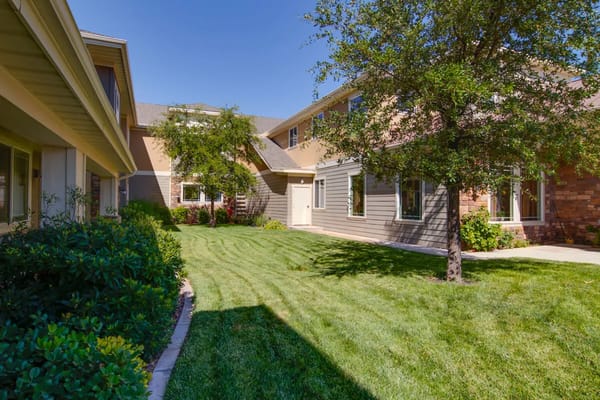 Well-maintained garden area with trees and grass