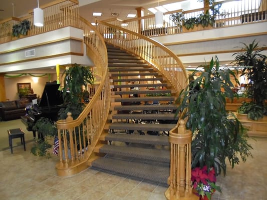 Elegant interior staircase with plants in lobby