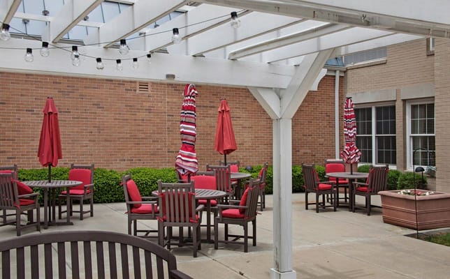 Outdoor patio area with red umbrellas and furniture