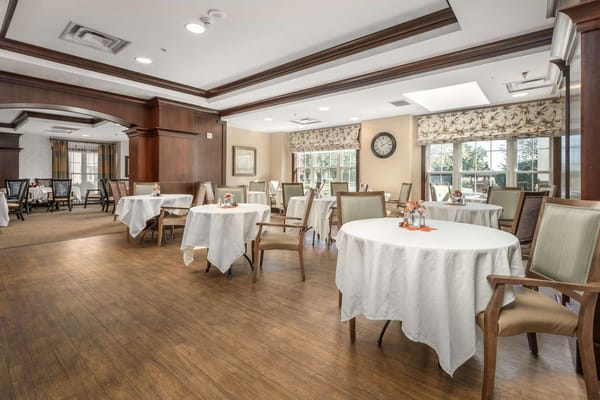 Dining area with tables set for residents