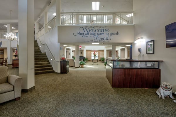 Lobby area with a welcome sign and stairs