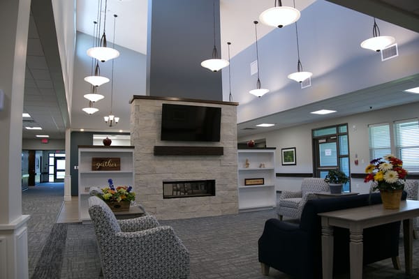 Bright common area with fireplace and seating