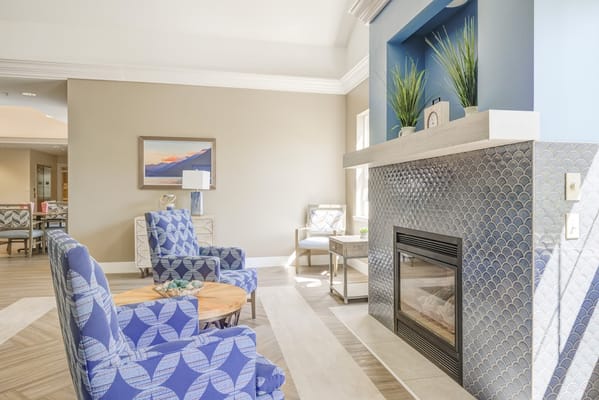 A cozy common area with seating and a fireplace