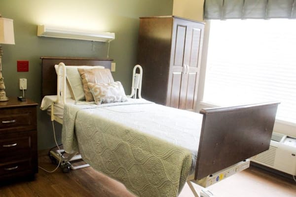 Well-furnished resident room with adjustable bed and window