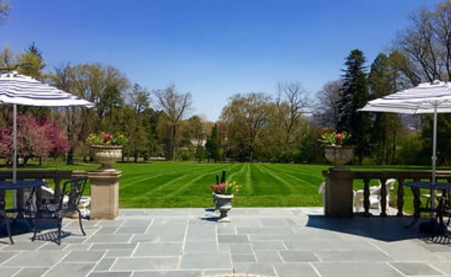 Outdoor patio area with seating and gardens