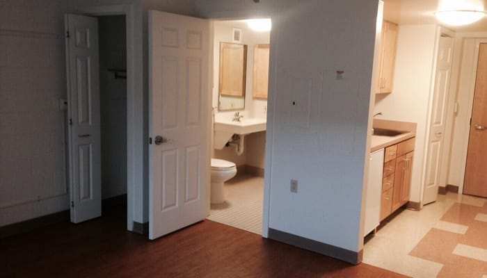 Interior view of a kitchen and bathroom in an apartment.