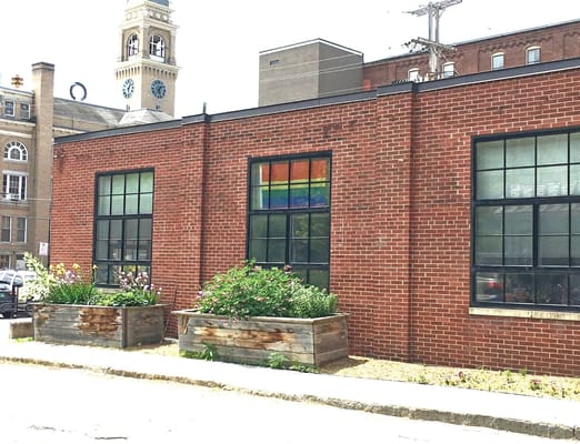 Exterior view of facility with garden and rainbow decoration