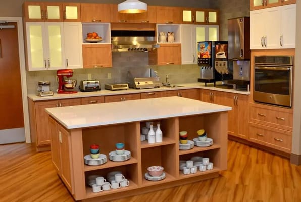 Modern kitchen area in Wellbrooke of Carmel with appliances and dining supplies.