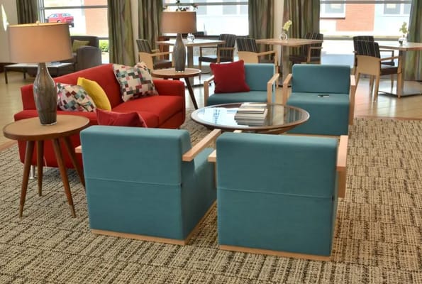 Brightly decorated lounge area with seating and tables