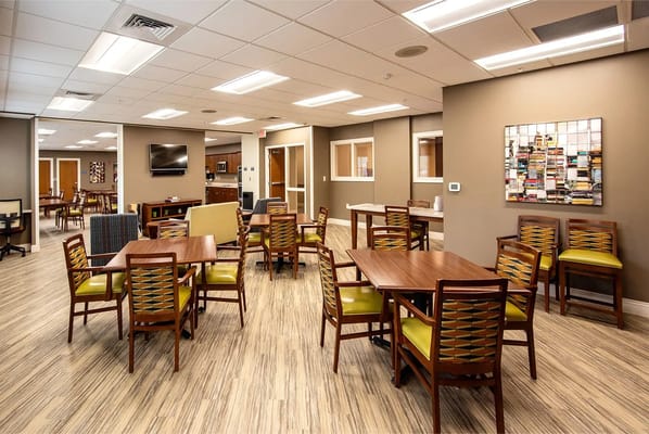 Bright common area with tables and chairs in Woodland Terrace.