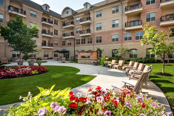 Garden area with colorful flowers and seating at Woodland Terrace of Carmel