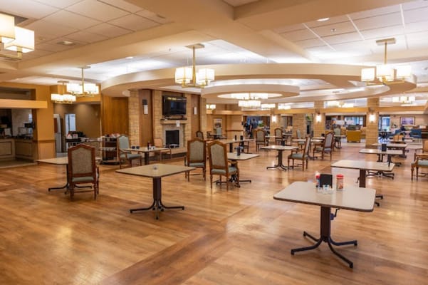 Dining area with tables and chairs in a well-lit room