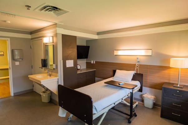 Private resident room with a hospital bed and amenities