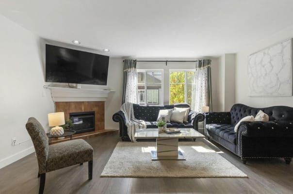 A cozy common area with seating and a fireplace