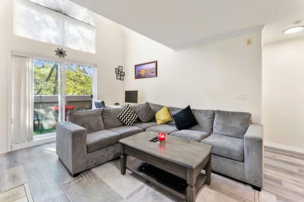 Cozy common area with a grey couch and table