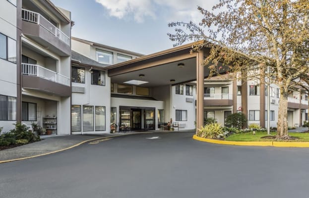 Entrance to Holiday Capital Place nursing facility with landscaping