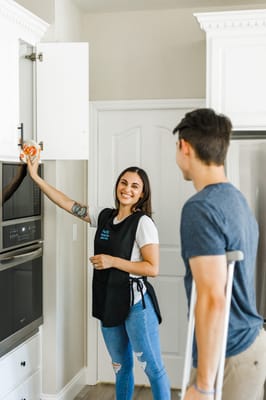 Staff member assisting a resident in the kitchen