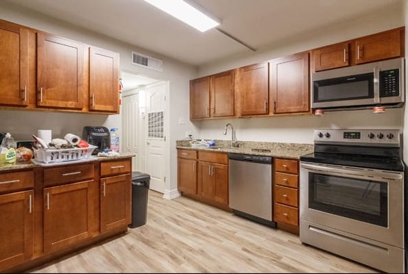 Kitchen area with wooden cabinets and stainless steel appliances