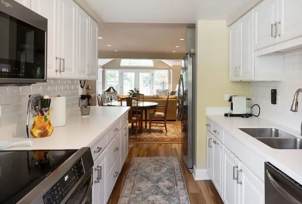 Bright kitchen leading to a dining area with a table
