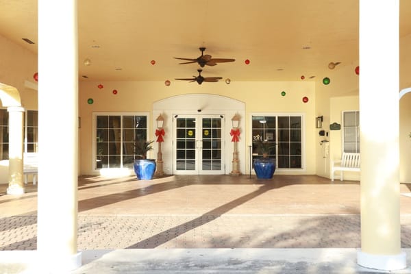 Entrance of a senior living facility decorated for the holidays