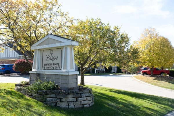 Sign for an assisted living facility surrounded by trees