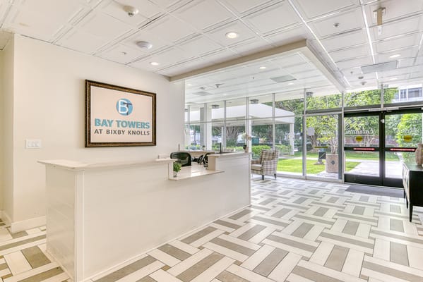 Bright lobby area with reception and outdoor view