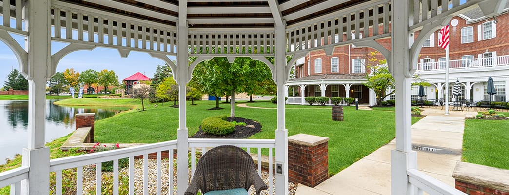 Gazebo overlooking a manicured lawn and pond