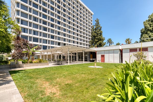 Exterior view of a senior living facility with outdoor space