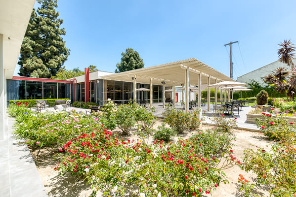 Outdoor dining area with flowers and seating