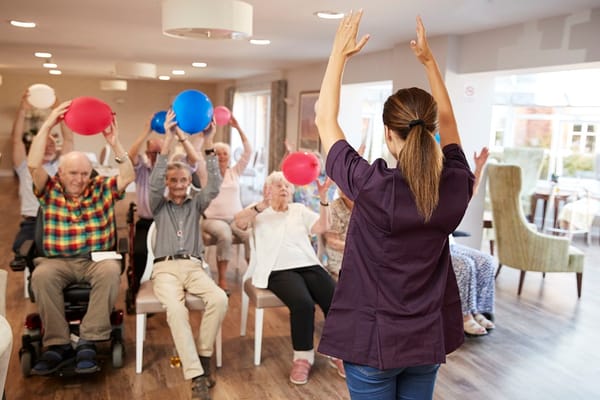 Residents participating in an engaging activity with balloons