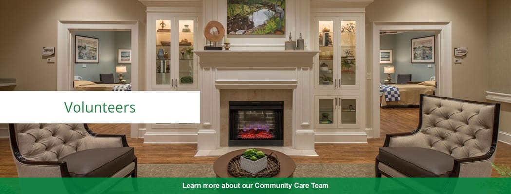 Interior view of a cozy common area with chairs and fireplace