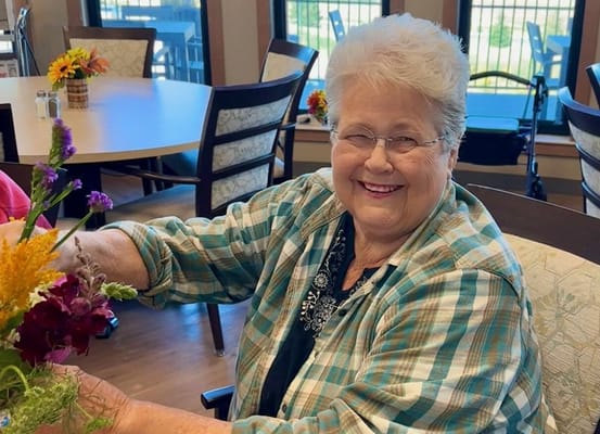 Resident engaging in flower arrangement activity