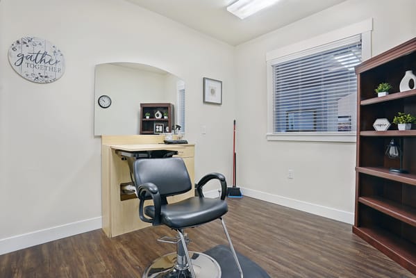 Interior view of a hair salon with a stylist chair